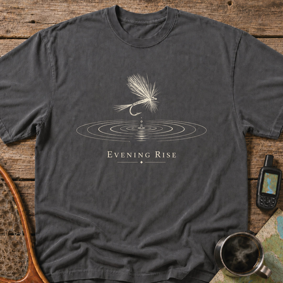Minimalist dry fly floating above expanding water rings during an evening trout rise.