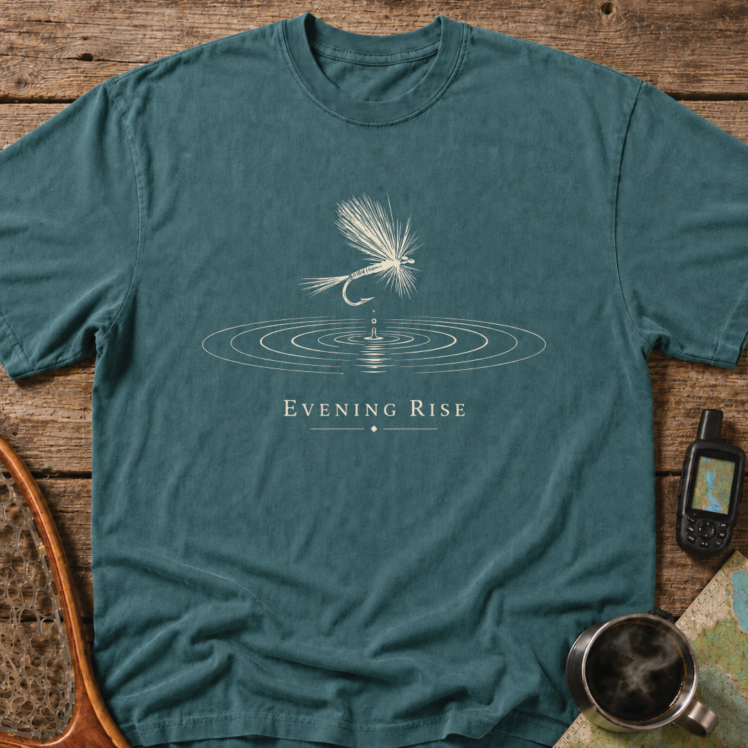 Minimalist dry fly floating above expanding water rings during an evening trout rise.