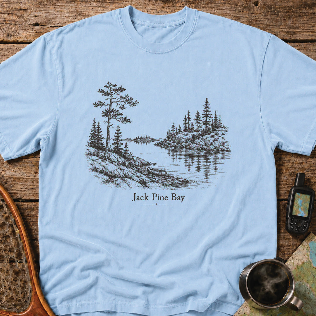 Jack Pine Bay t-shirt featuring a granite shoreline with jack pine overlooking calm water.