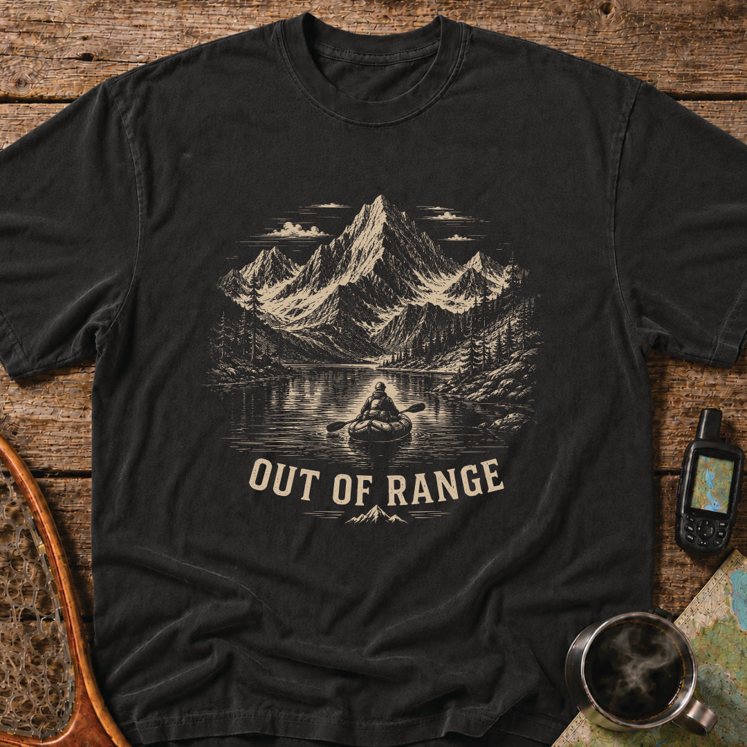 Out Of Range t-shirt featuring a packrafter paddling across an alpine mountain lake.