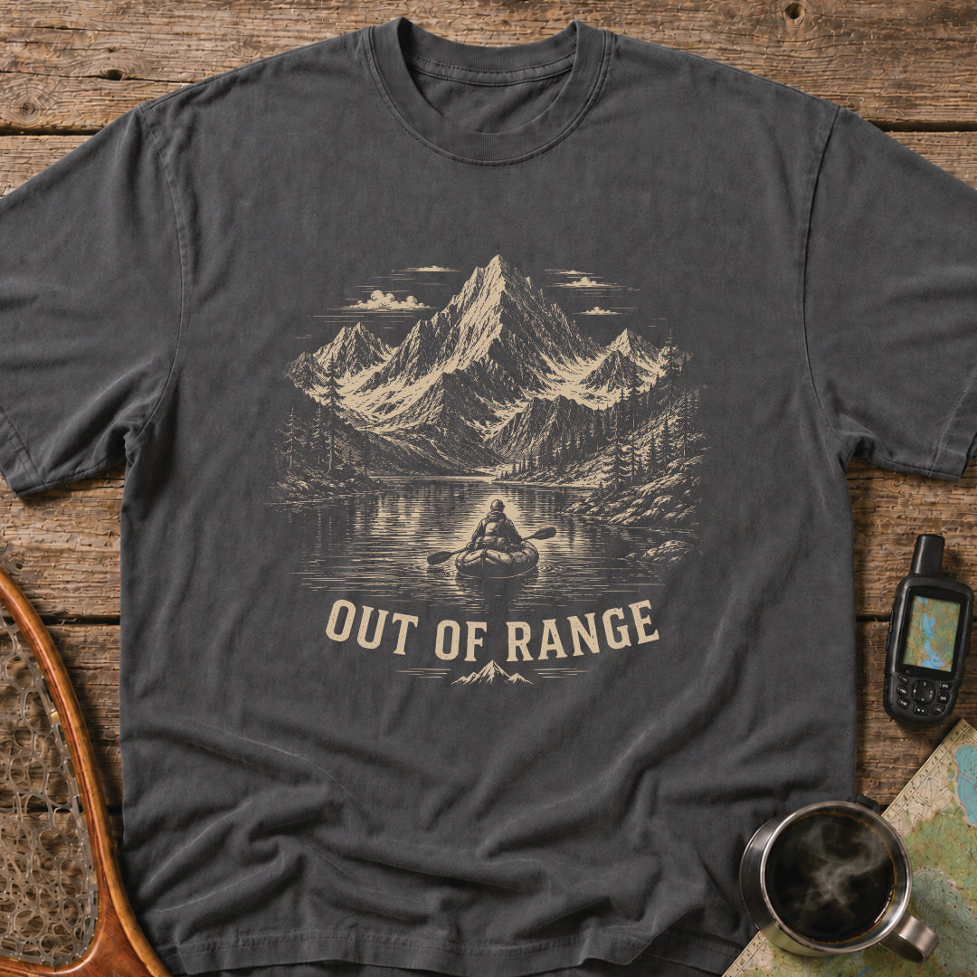 Out Of Range t-shirt featuring a packrafter paddling across an alpine mountain lake.