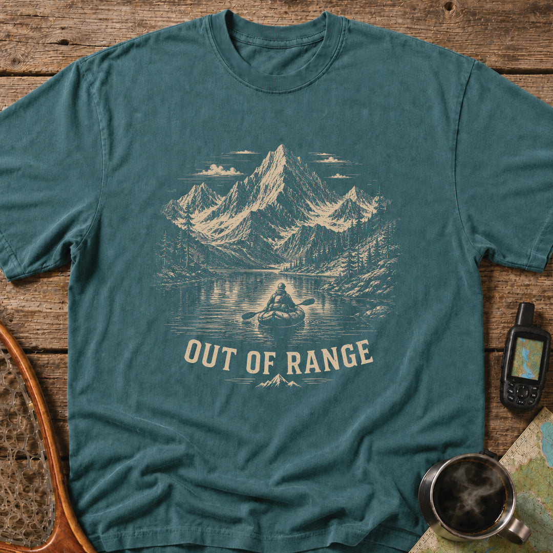 Out Of Range t-shirt featuring a packrafter paddling across an alpine mountain lake.