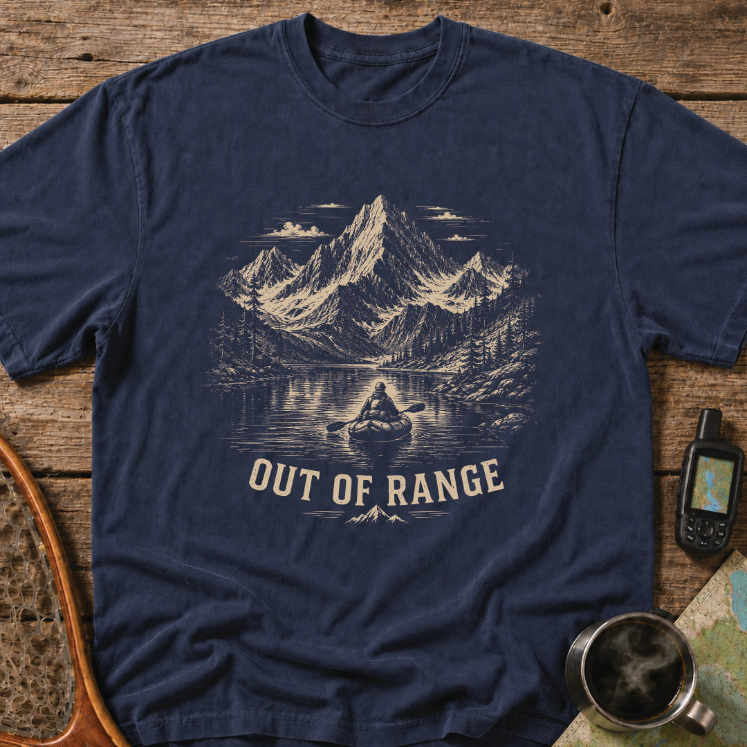 Out Of Range t-shirt featuring a packrafter paddling across an alpine mountain lake.