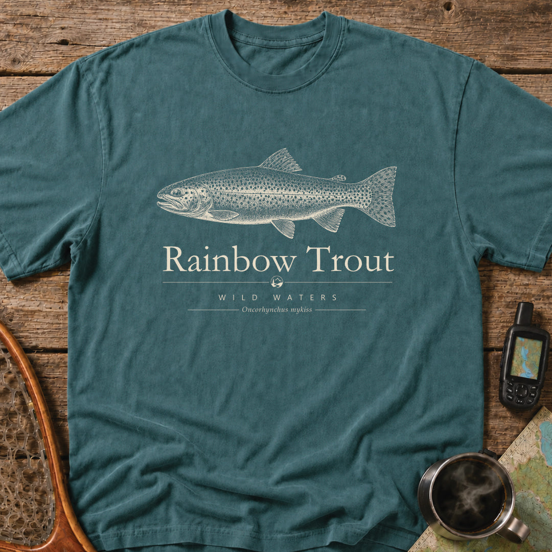Blue Spruce Comfort Colors T-shirt featuring a vintage cream rainbow trout illustration, Wild Waters typography, and the scientific name Oncorhynchus mykiss.