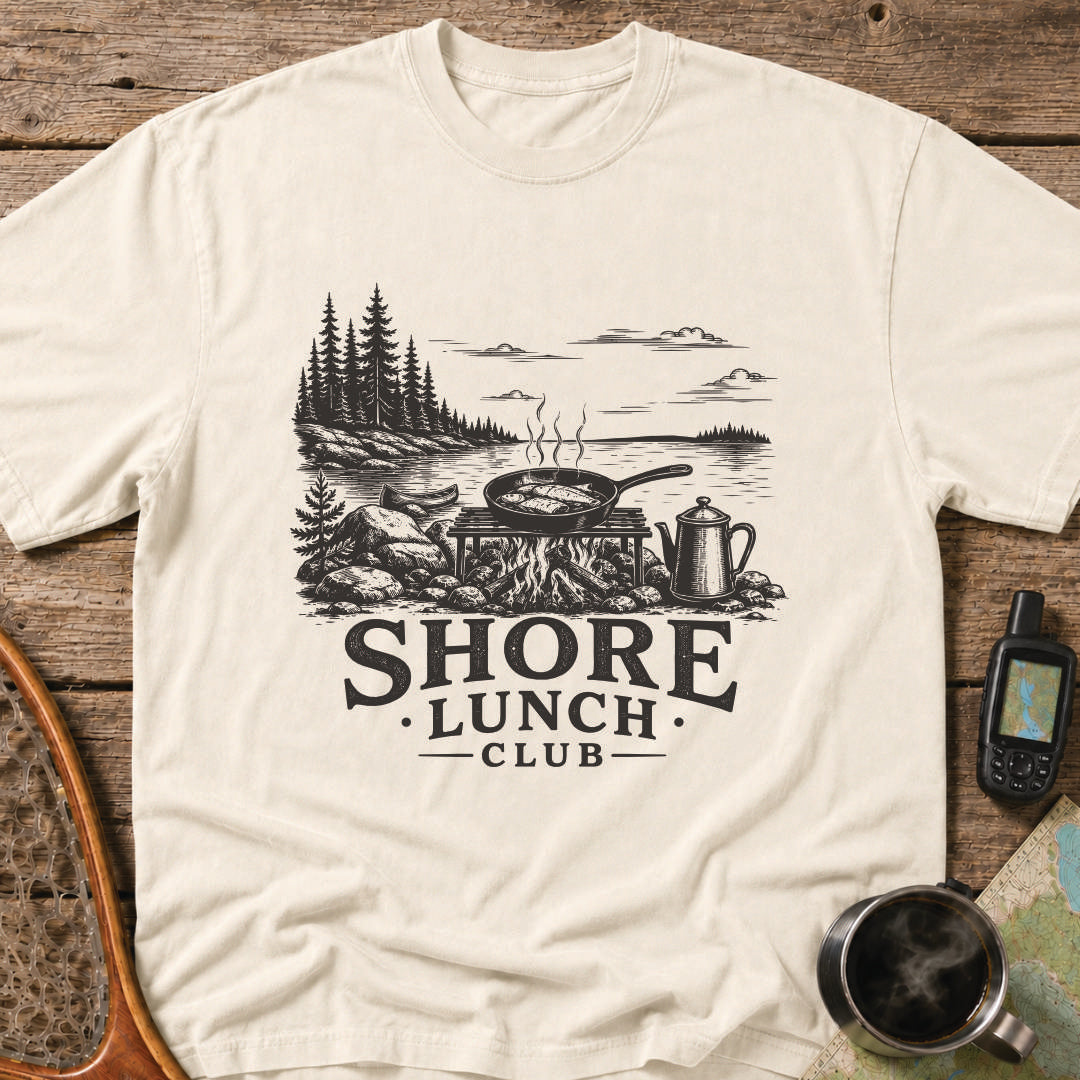 Granite Shore t-shirt featuring a rocky northern shoreline with pine trees overlooking calm wilderness water.