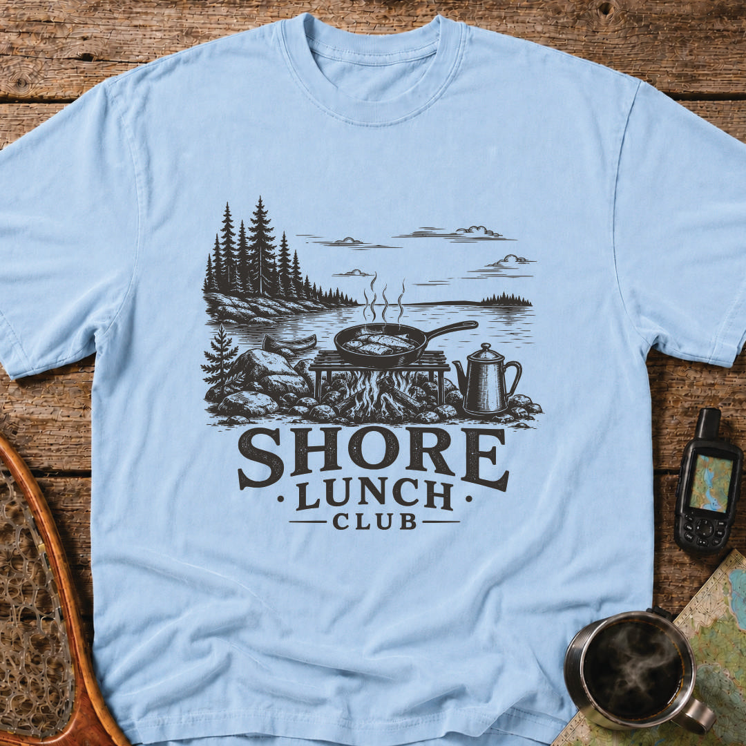Granite Shore t-shirt featuring a rocky northern shoreline with pine trees overlooking calm wilderness water.