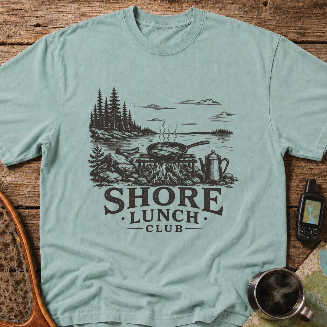 Granite Shore t-shirt featuring a rocky northern shoreline with pine trees overlooking calm wilderness water.