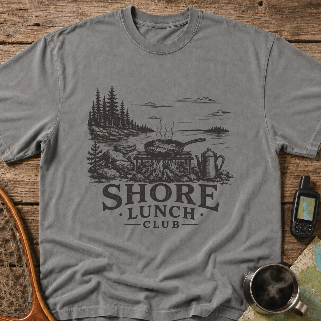 Granite Shore t-shirt featuring a rocky northern shoreline with pine trees overlooking calm wilderness water.