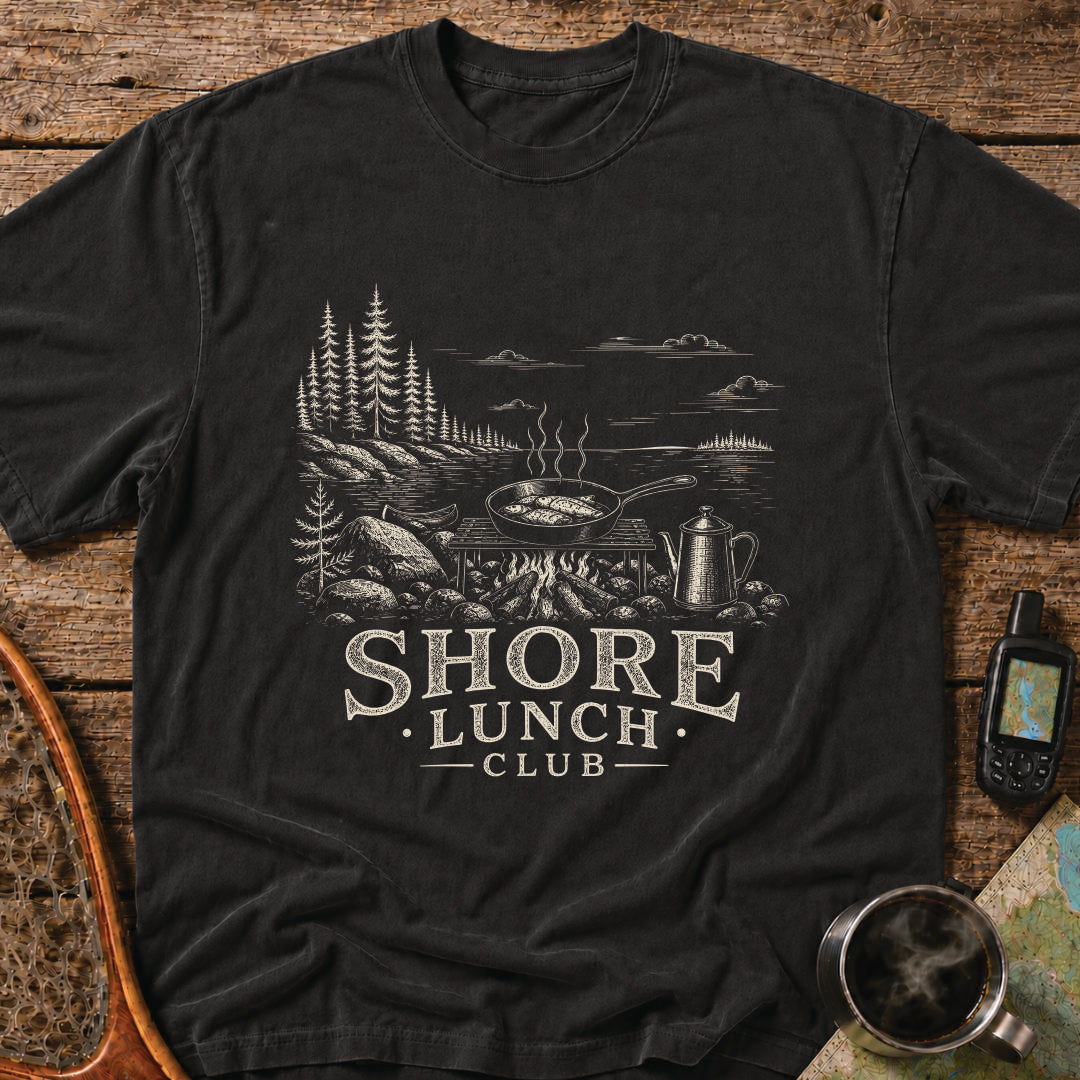 Granite Shore t-shirt featuring a rocky northern shoreline with pine trees overlooking calm wilderness water.