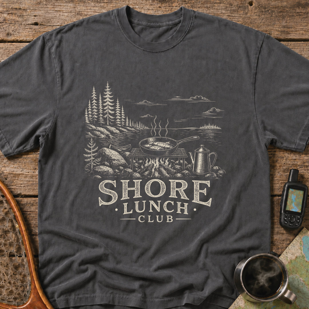 Granite Shore t-shirt featuring a rocky northern shoreline with pine trees overlooking calm wilderness water.
