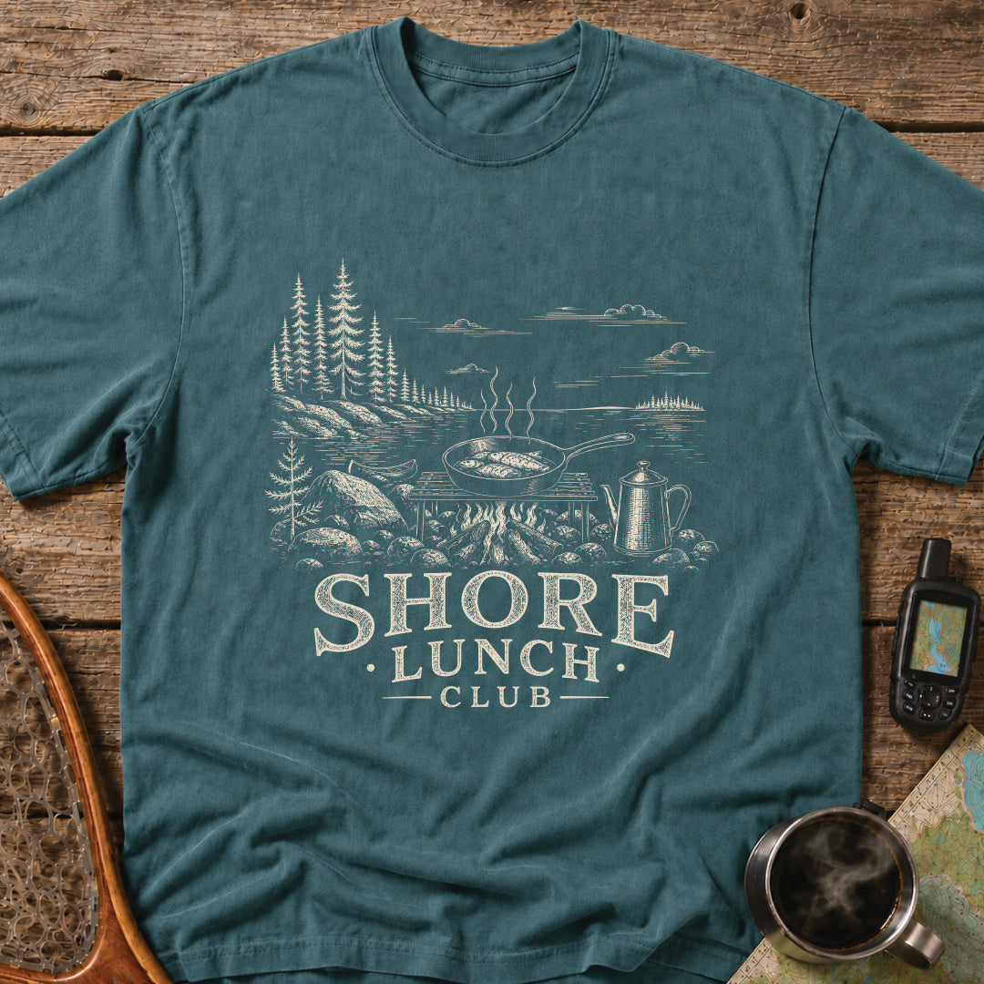 Granite Shore t-shirt featuring a rocky northern shoreline with pine trees overlooking calm wilderness water.