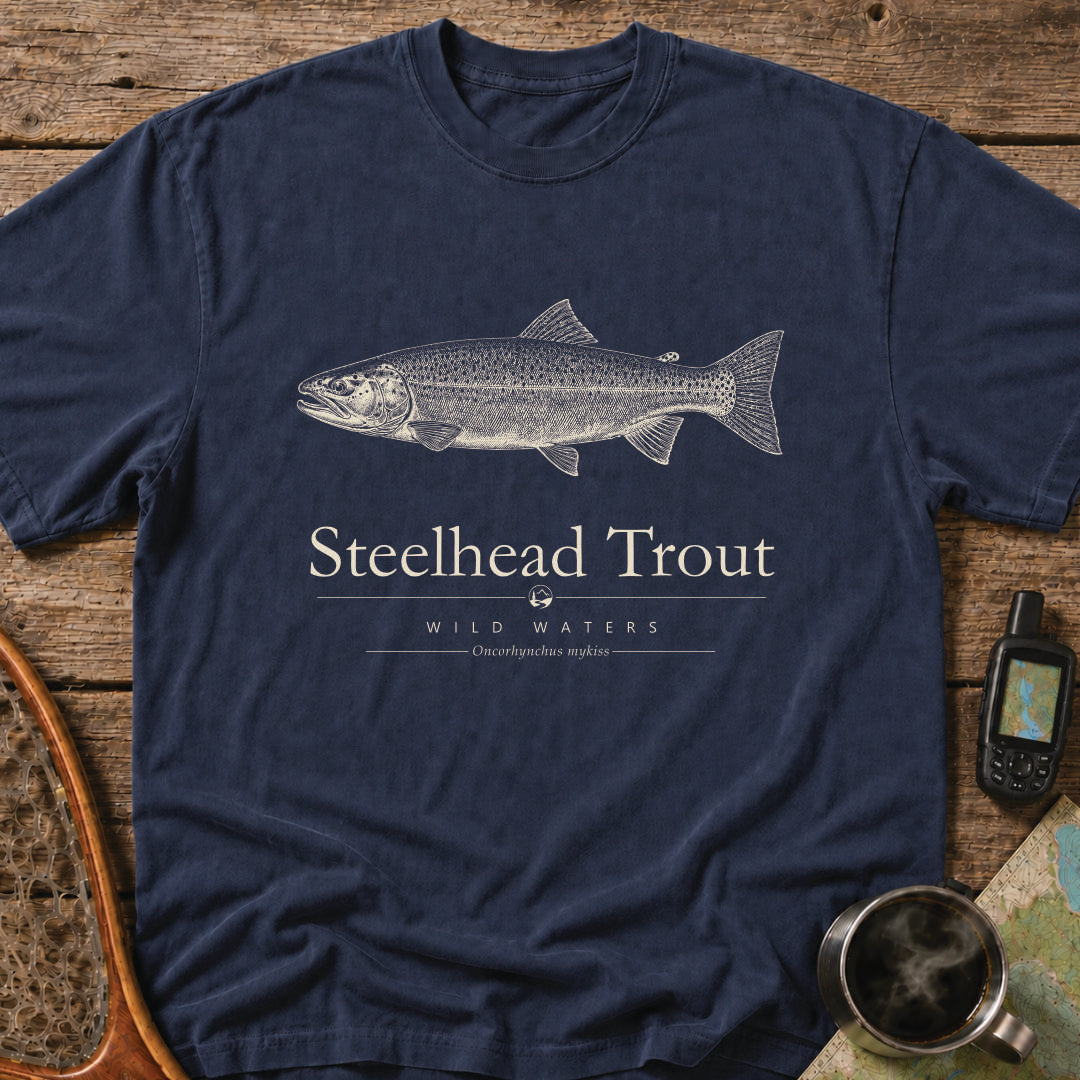 Navy Comfort Colors T-shirt featuring a vintage cream steelhead trout illustration, Wild Waters typography, and the scientific name Oncorhynchus mykiss.