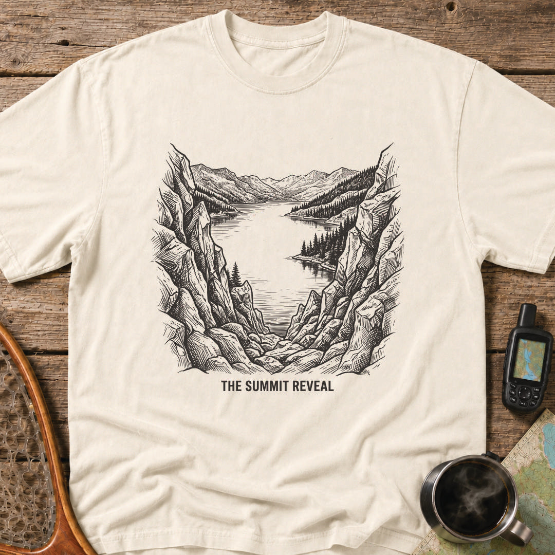 The Summit Reveal t-shirt featuring a dramatic mountain overlook above an alpine lake.