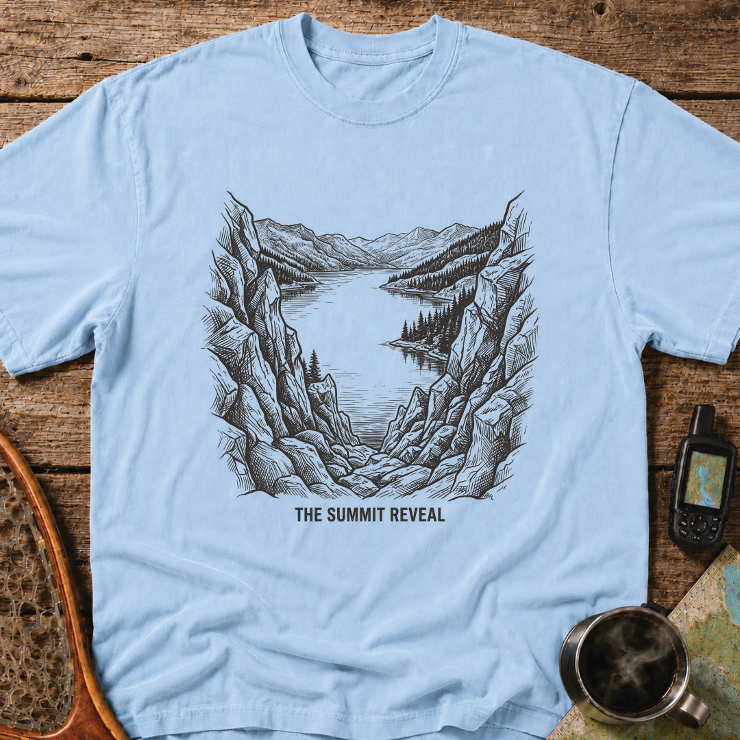 The Summit Reveal t-shirt featuring a dramatic mountain overlook above an alpine lake.