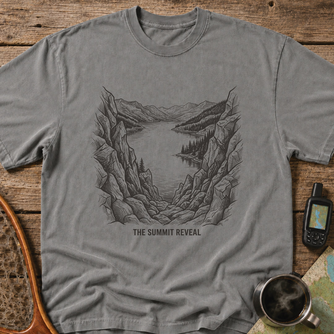 The Summit Reveal t-shirt featuring a dramatic mountain overlook above an alpine lake.